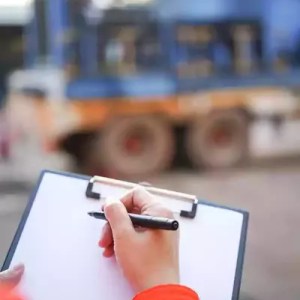 worker inspecting factory equipment undergoing conformity assessment protocol