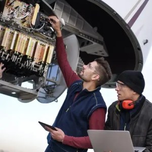 Engineers inspecting an international plane is safe for travel.